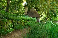 Woodland garden with outbuilding - Asthall Manor, Oxfordshire