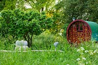 Meadow garden with modern sculptures and caravan - Asthall Manor, Oxfordshire

