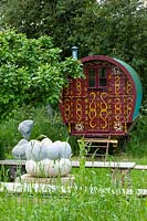 Meadow garden with modern sculptures and caravan - Asthall Manor, Oxfordshire