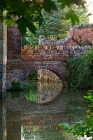 View of stone and brick bridge over the moat in summer