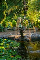 Lily pond with cherub fountain sculpture