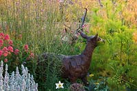 Deer sculpture in amongst a border of Stachys byzantina 'Silver Carpet', fennel, Centranthus ruber and Stipa gigantea