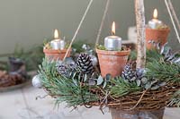 Close up detail of rustic advent candle holder lit