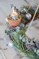 Close up detail of rustic advent candle holder lit