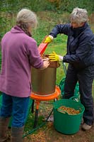 Hydropress pressing system that uses mains water pressure to extract high levels of juice from milled apples and pears in use at Community apple juicing day in Sampford Peverell, Devon, late October  - loading with apple pulp