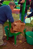 Rack & Cloth Screw Press in use at Community apple juicing day in Sampford Peverell, Devon, late October - preparing to load with apple pulp