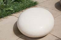 Large round smooth white stone as garden sculpture. Brewin Dolphin Garden, RHS Chelsea Flower Show. Designer Robert Myers