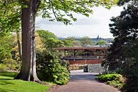 View to the new John Hope Gateway visitor centre at RBG Edinburgh, Scotland with the city of Edinburgh in the background.