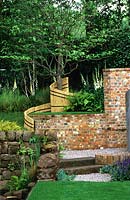 Summer garden with mixed hardscaping, ornamental tree & perennial plants