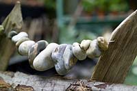 Rustic chestnut fence with detail of threaded beach pebbles