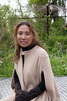 Quiet Time: DMZ Forbidden Garden. Designer of the 'Quite Time' Jihae Hwang sitting in her garden