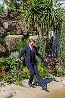 RHS Chelsea Flower Show 2014.  Alan Titchmarsh 'dipping his toe' into his own garden pond. 