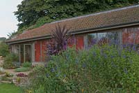 Special Plants ( Derry Watkin's garden ), Bath, UK. Late summer, architect designed barn in Somerset hills
