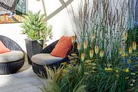 Hampton Court Flower Show 2014, the Hedgehog St Garden, des. Tracy Foster. Small patio garden with modern wicker seats