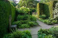 Kiftsgate Court, Gloucestershire, UK, ( Chambers ) Summer. Tranquil corner planted with ferns and shade loving foliage plants