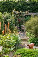 18 Queens Gate, Bristol, UK ( Sheila White ) small town garden in summer. paved stepping stone path leading to pergola