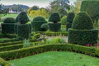 Owlpen Manor, Gloucestershire, UK. Autumn, view across the topiary garden