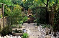 Hallowell Rd Middx design Alan Titchmarsh Japanese style garden with arch pebbles stones cat wooden fence stepping stones water