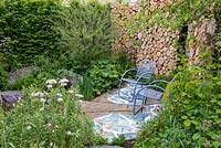 Viking Cruises: The Art of Viking Garden ayRHS Chelsea Flower Show 2019. Seats in front of a wall made from sawn timber logs
Design: Paul Hervey-Brookes, Sponsor: Viking Cruises