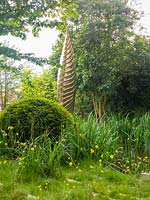 The Savills and David Harber Garden is a green garden depicting a sustainable woodland clearing. Designed by Andrew Duff, Sponsored by David Harber Savills, RHS Chelsea Flower Show, 2019.