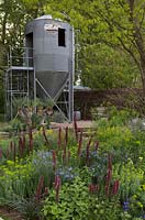 The Resilience Garden at RHS Chelsea Flower Show - View to the grain silo. Designer: Sarah Eberle