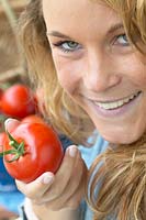 Woman holding tomato