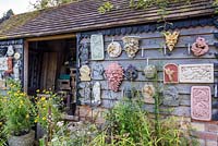 Nursery shed with plaster plaques, Hilltop garden, July.
