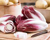 Radicchio Rosso on a kitchen chopping board with knife