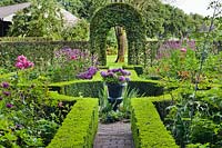 Knot garden with decorative urn planted with hydrangea. 