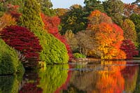 Autumnal trees reflected in lake, National Trust - Sheffield Park and Garden, East Sussex. 