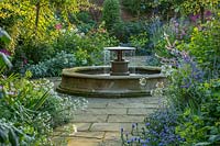 Circular fountain and flowers in borders, 'Blue' Echium vulgare 'Blue Bedder' - South Garden, Morton Hall, Worcestershire

