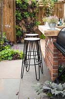 Rustic outdoor kitchen bar with stools