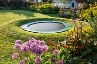 View of garden with sunken trampoline.  