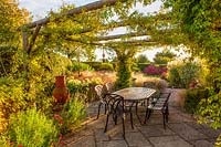 Pergola with patio, metal table and chairs