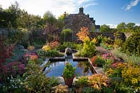 Walled garden featuring mirror pool and autumn colour.