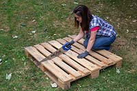 Using a saw to cut a pallet in half