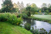 The River Whitewater runs through the garden, once providing water to power the mill. Dipley Mill, Hartley Wintney, Hants, UK