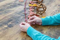 Securing decorations to advent branch with copper floristry wire