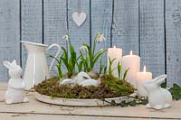 Easter themed table setting with Snowdrops - Galanthus woronowii, ceramic rabbits and eggs