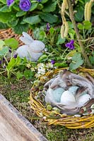 Wooden box with Easter nest made from willow twigs and coloured eggs