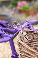 Woven basket tied to handlebars with string