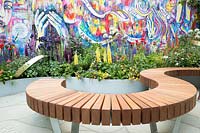 The Supershoes, Laced With Hope Garden - urban garden wall with graffiti, curved wooden bench and mixed border - RHS Chelsea Flower Show, 2018 - Sponsor: Frosts Garden Centres