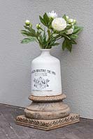 Floral arrangement - artificial Peonies in vintage bottle