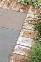 Brick edged paving with mixed planting