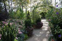 Rose arbour and mixed planting. Le Jardin Anglais. The English Garden. 
Permanent Garden in the Pres du Goualoup. Festival des Jardins 2018, Chaumont 
sur Loire, France 
