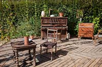 Old furniture, chairs, tables, dresser and piano, an allegory of Marcel 
Proust's life. Le Jardin de Proust. Proust's Garden.  Festival garden.
 Garden of Thought.  Festival des Jardins 2018, Chaumont sur Loire, France 