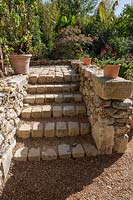 Steps constructed of rough blocks and bricks. Le Jardin de Proust. 
Proust's Garden. Festival garden. Garden of Thought. 
Festival des Jardins 2018, Chaumont sur Loire, France