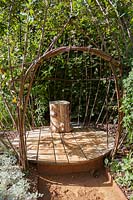Wooden seat in wicker cage. Dans Ma Bulle, In My Bubble. Garden of Thought.  Festival des Jardins 2018, Chaumont sur Loire, France 