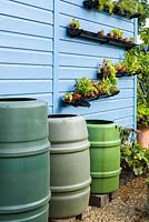 Water butts and blue shed. 'RHS Grow Your Own with The Raymond Blanc Gardening School', RHS Hampton Flower Show, 2018 