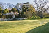 View across formal lawn to terraced garden beyond
